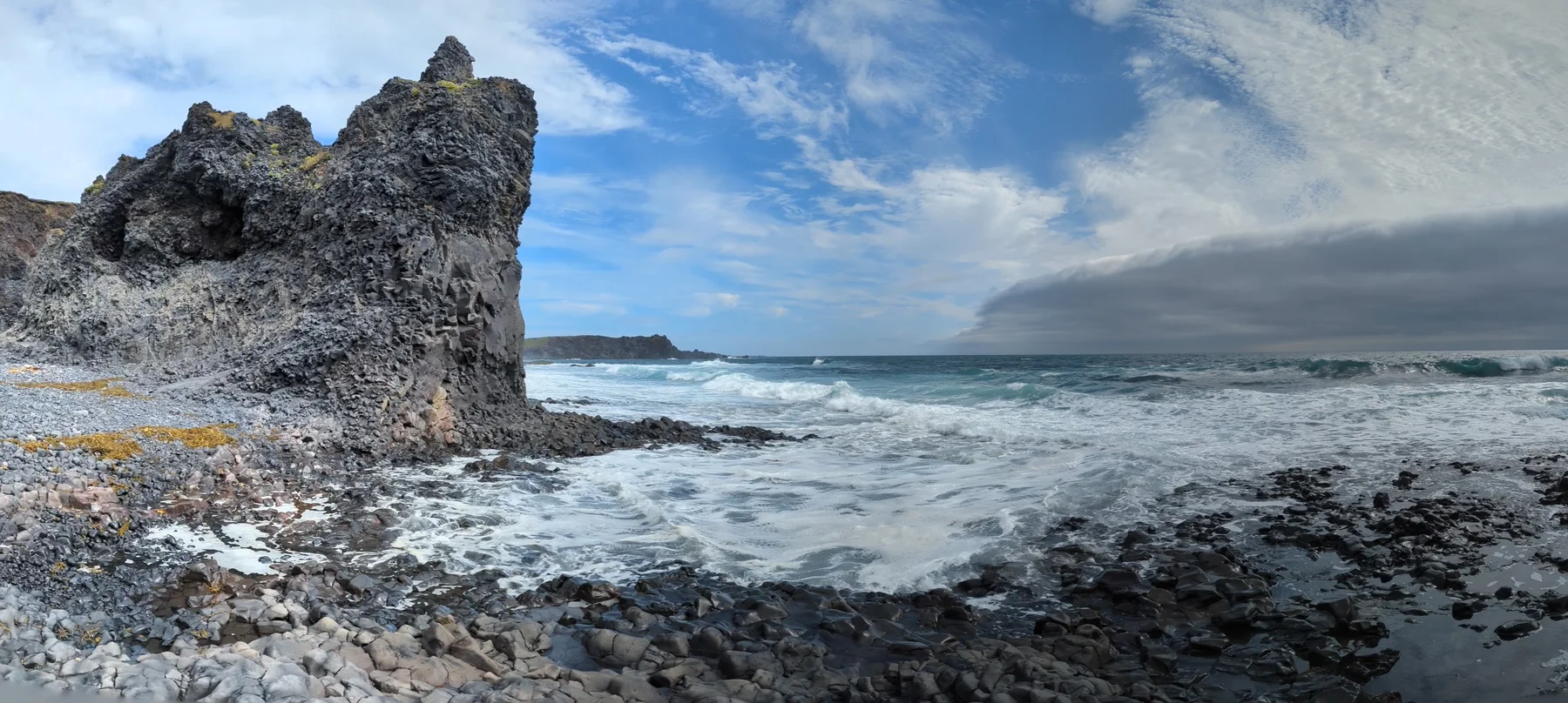 Black volcanic rock beside the sea